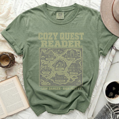 Green t-shirt with "Cozy Quest Reader" and a map of fantasy locations.