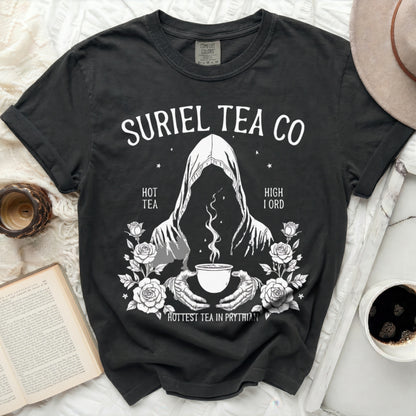 Dark t-shirt with white "Suriel Tea Co." graphic, hooded figure, and roses.