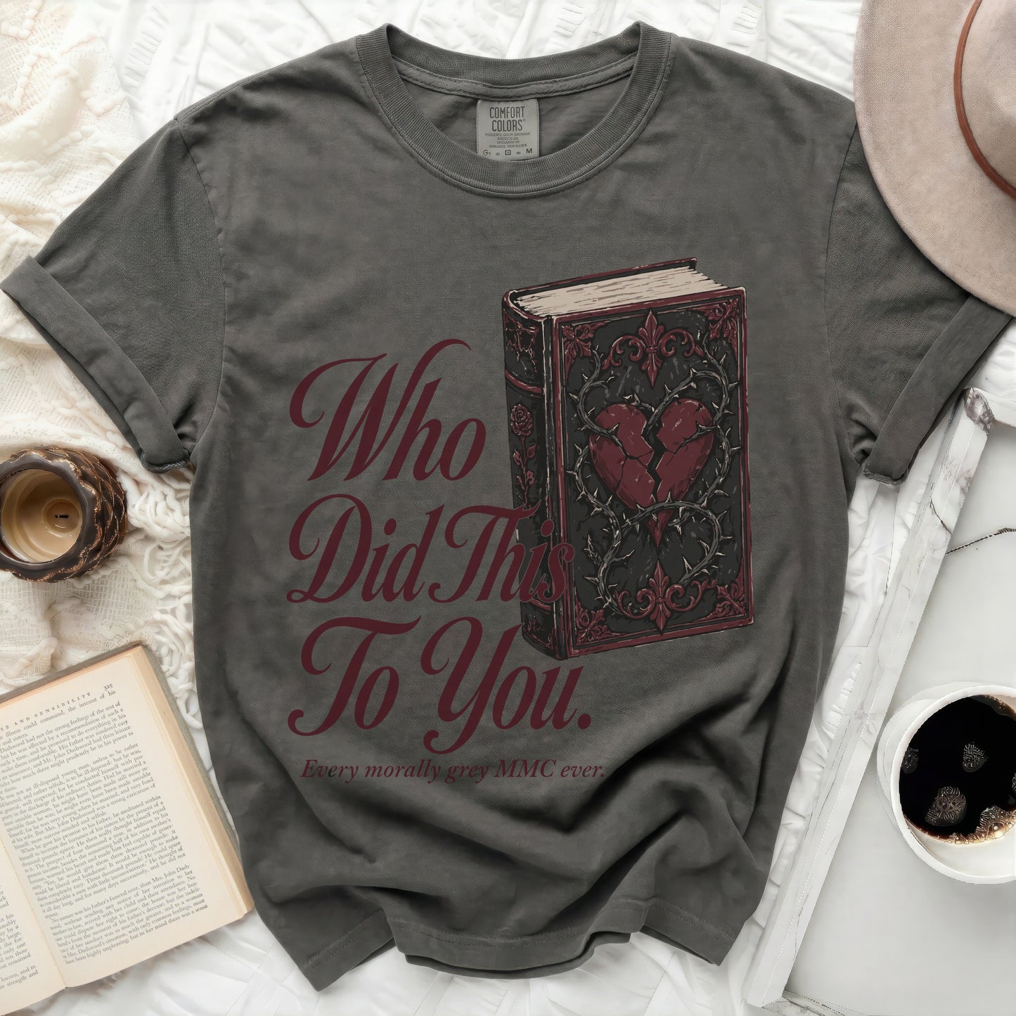 Dark grey t-shirt with "Who Did This To You." book graphic.