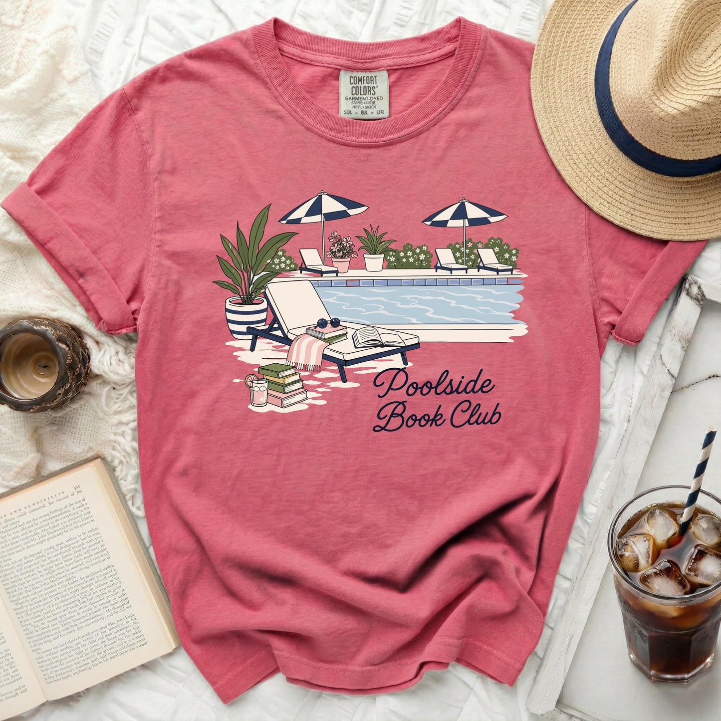 T-shirt with "Poolside Book Club" graphic featuring a pool and lounge chairs.