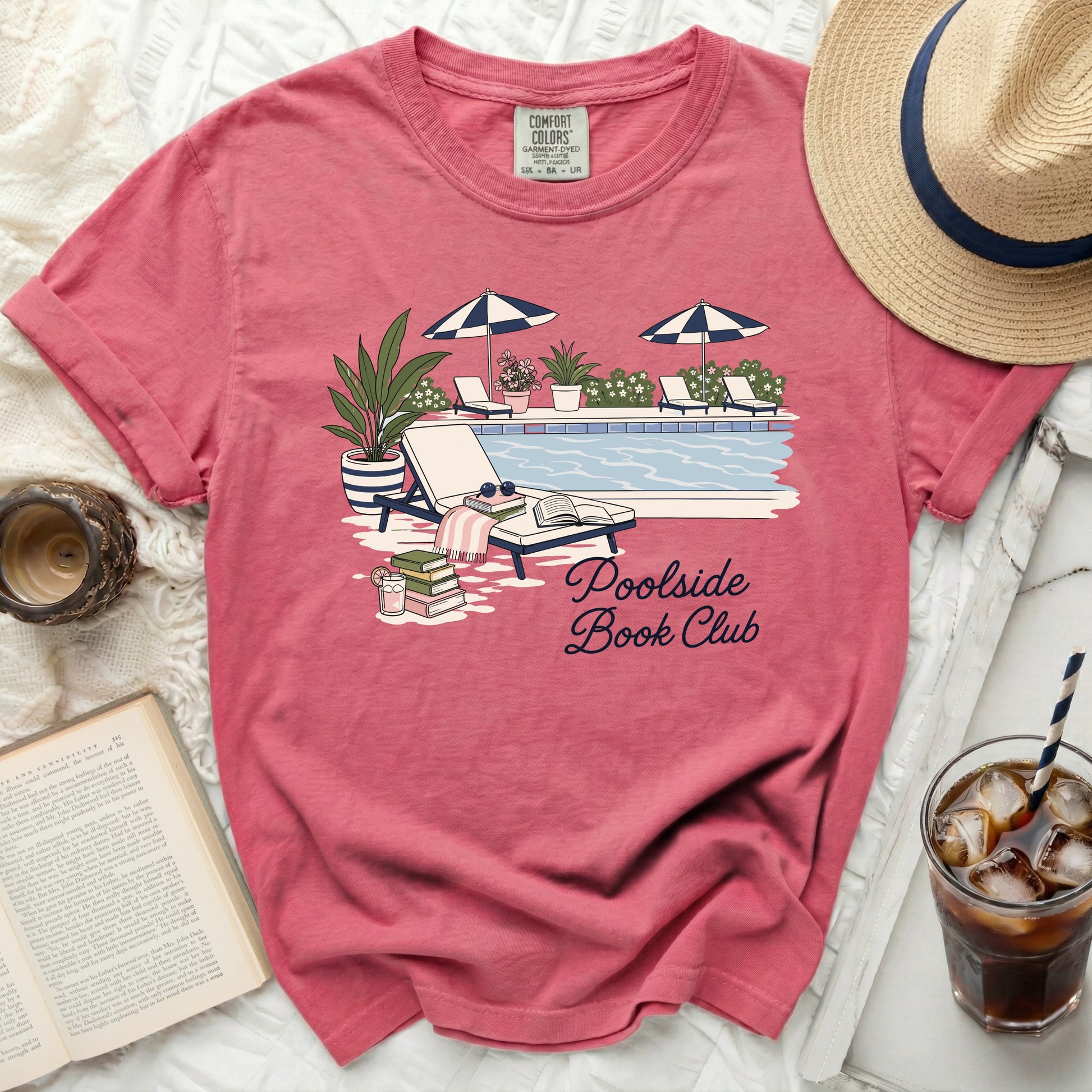 T-shirt with "Poolside Book Club" graphic featuring a pool and lounge chairs.