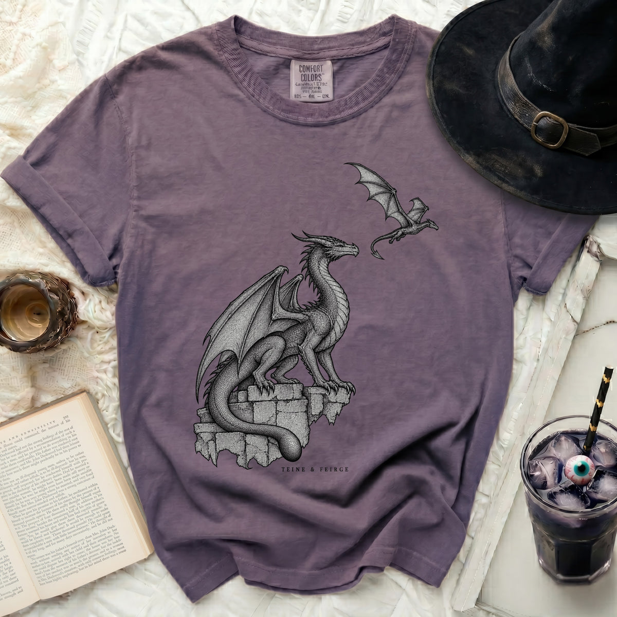Purple t-shirt with two grey dragons graphic and "TEINE & FEIRGE" text.