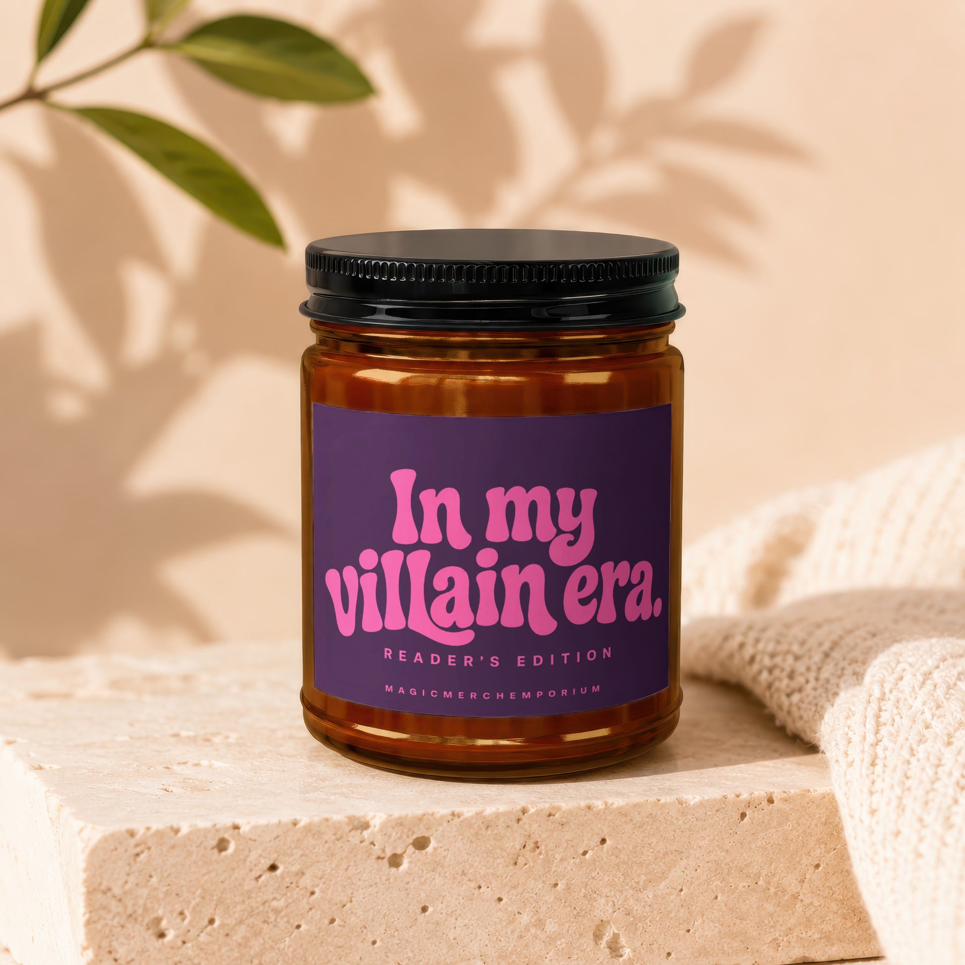 Glass candle with purple label reading "In my villain era. Reader's Edition."