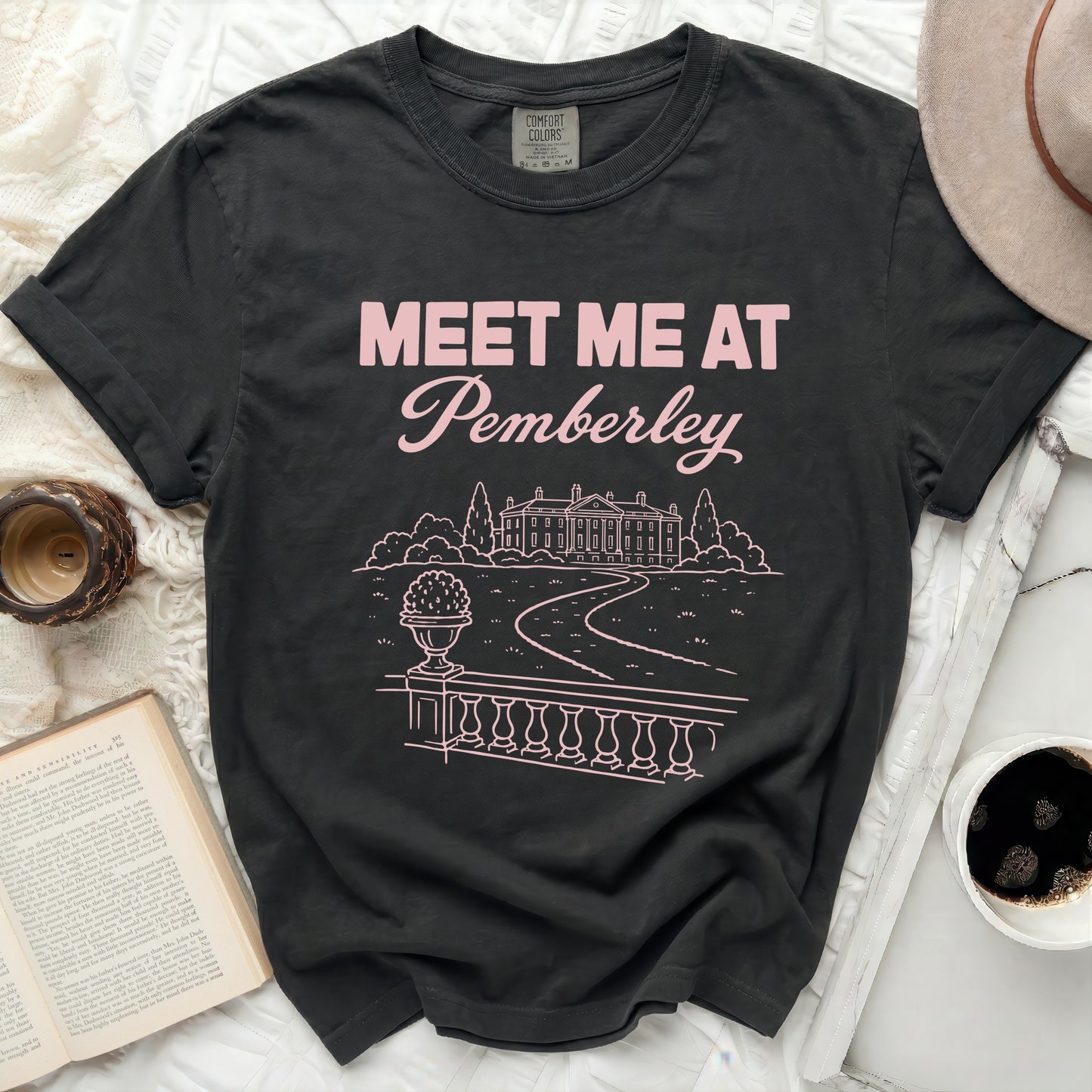 T-shirt with "Meet Me at Pemberley" text and line drawing of a mansion.