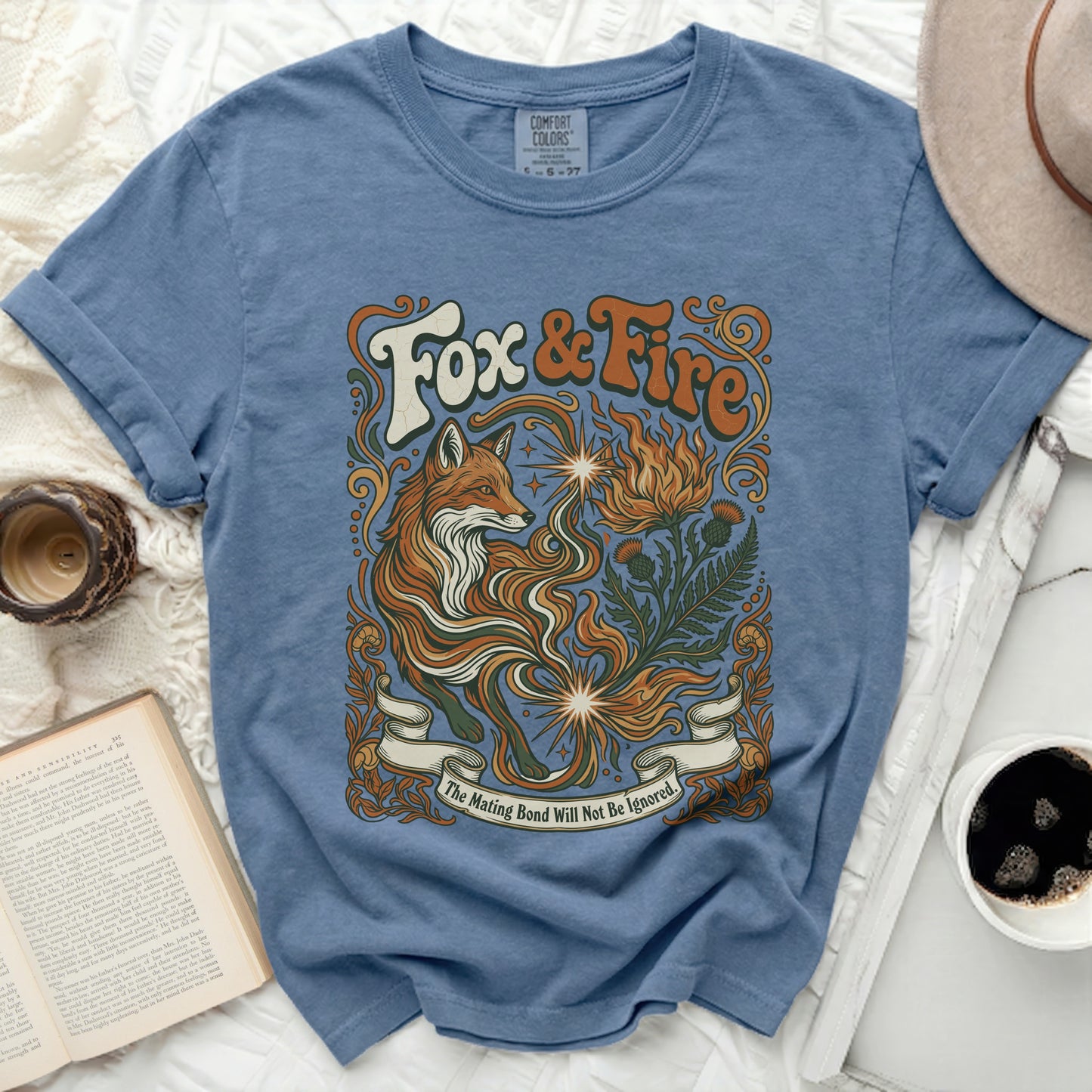 Blue t-shirt with a fox, fire, and plants graphic, "Fox & Fire" text.
