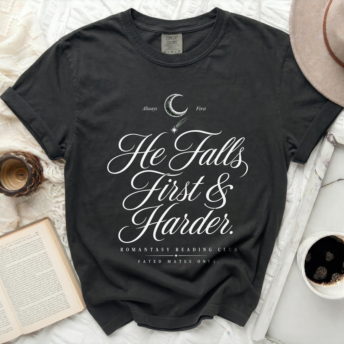 Dark t-shirt with "He Falls First & Harder" text and book.