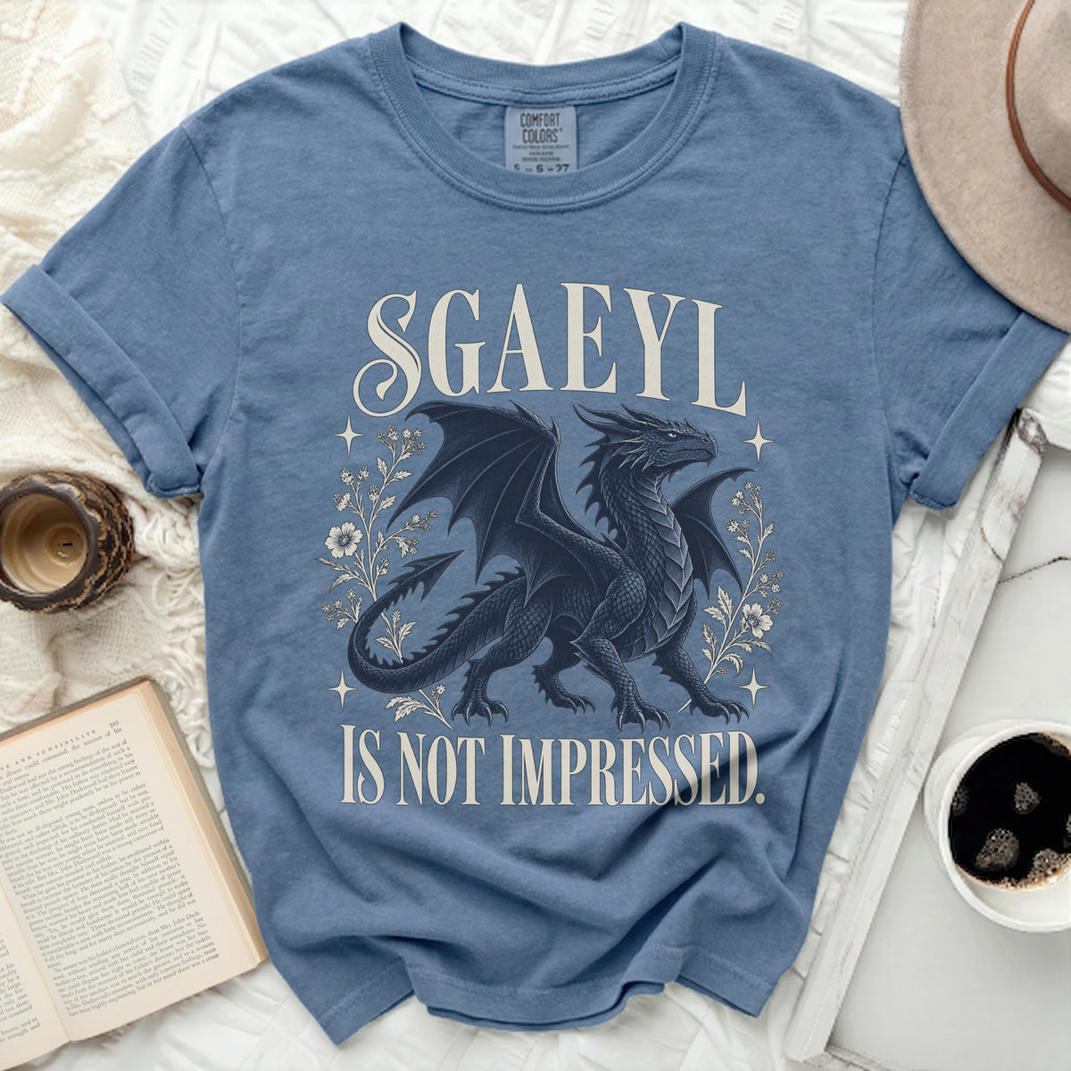 Blue t-shirt with black dragon graphic and text "SGAEYL IS NOT IMPRESSED."