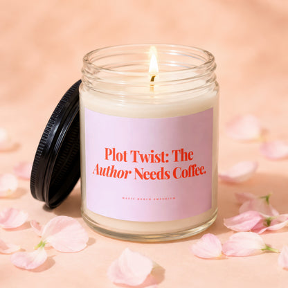 Lit candle with pink label reading "Plot Twist: The Author Needs Coffee."