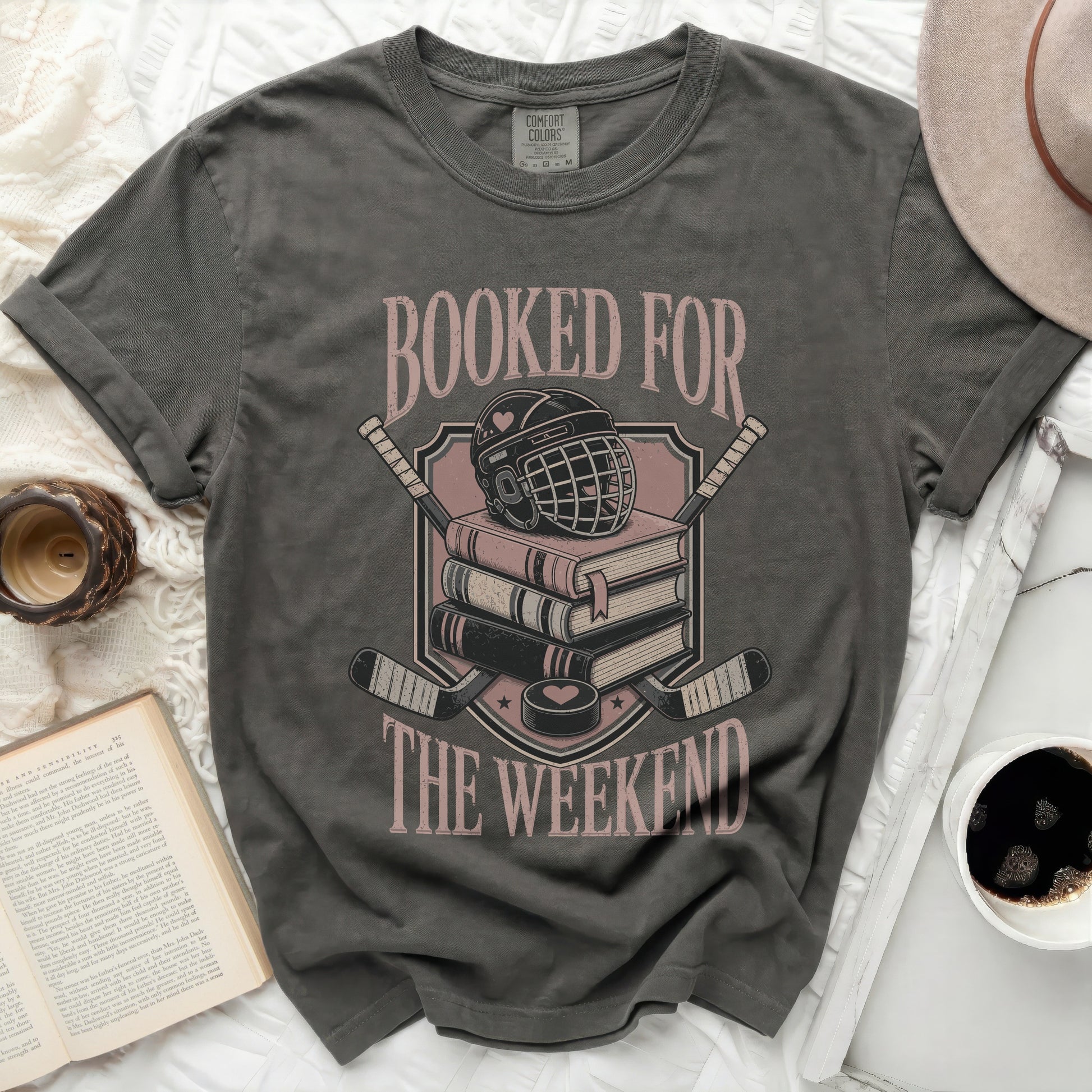 T-shirt with "Booked for the Weekend" text, hockey gear, and books.