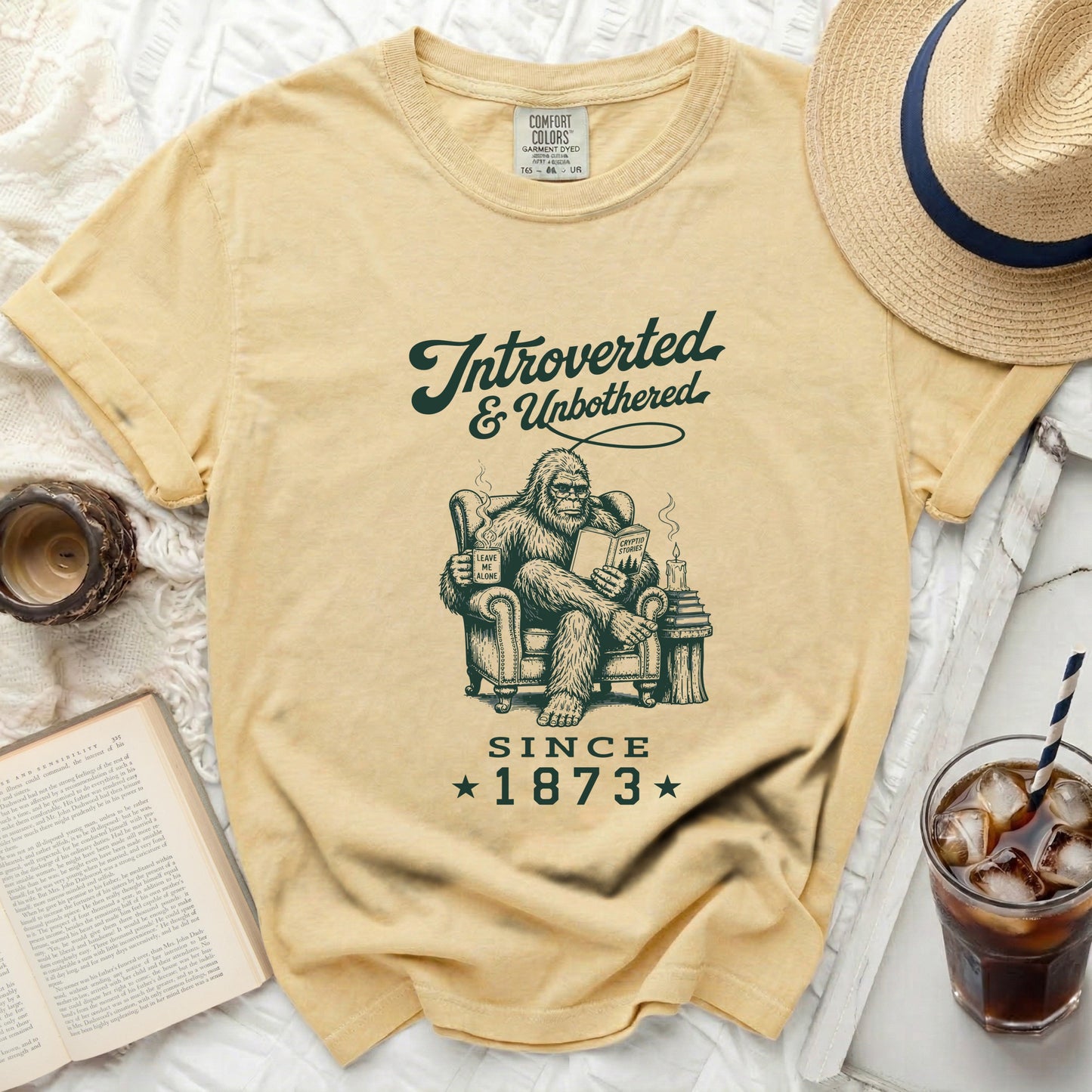 Yellow t-shirt with Bigfoot reading "Introverted & Unbothered Since 1873".