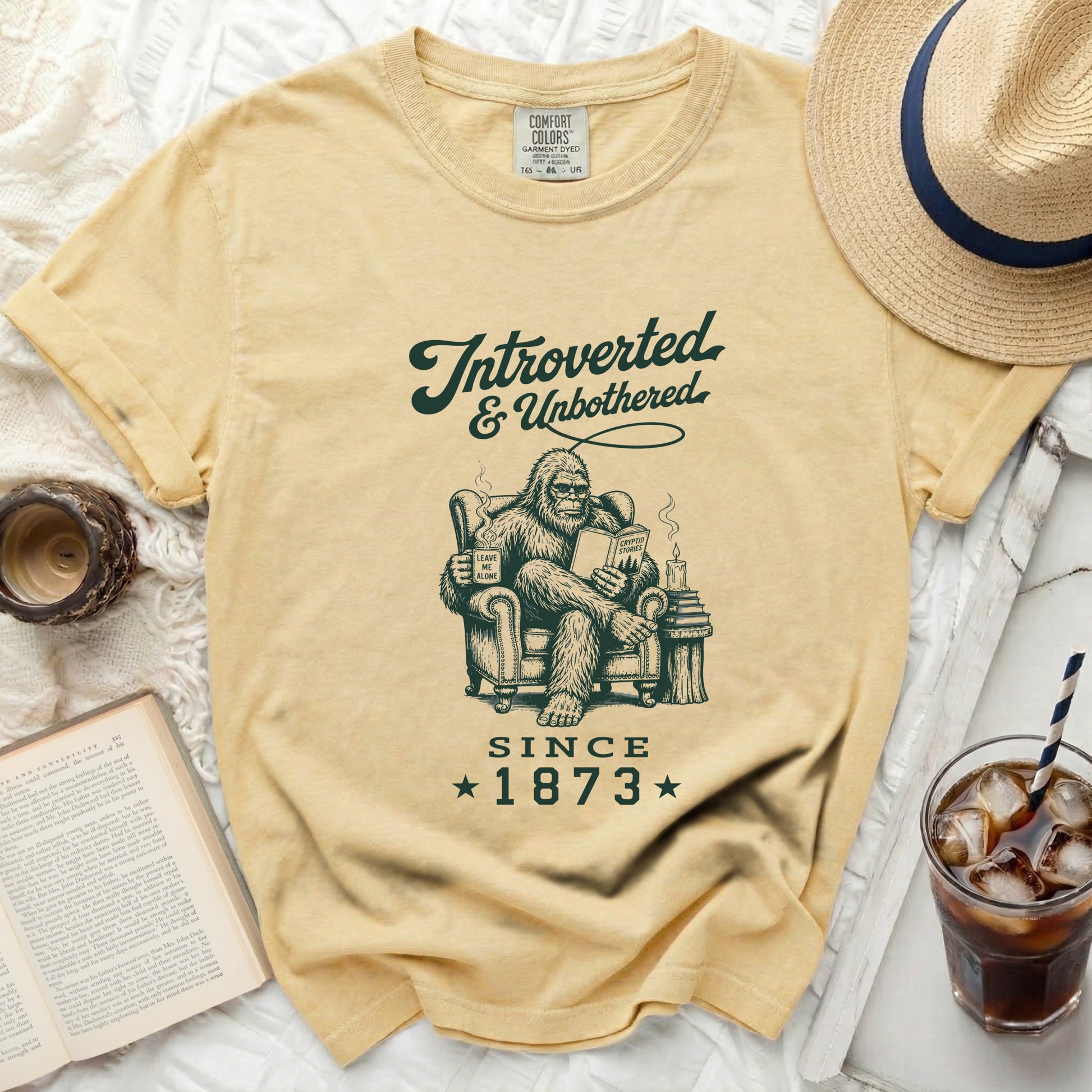 Yellow t-shirt with Bigfoot reading "Introverted & Unbothered Since 1873".