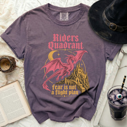 Purple t-shirt with a pink dragon, castle, moon, and text.