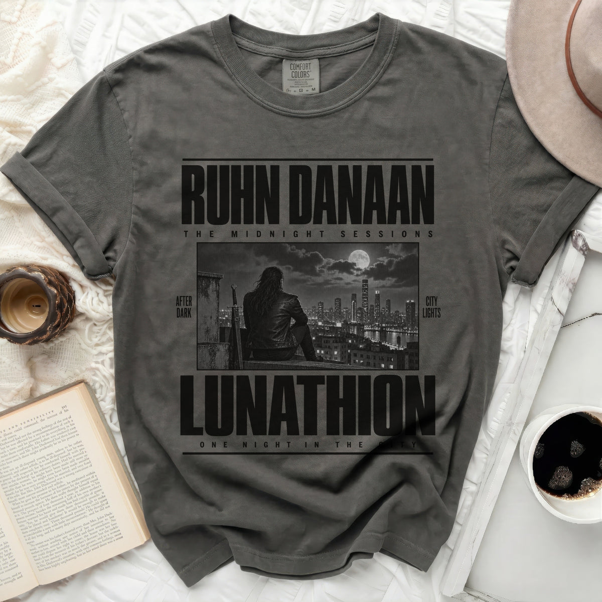 Dark gray t-shirt with "RUHN DANAAN LUNATHION" text and a night cityscape graphic.