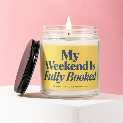 Glass jar candle with yellow label reading "My Weekend Is Fully Booked."