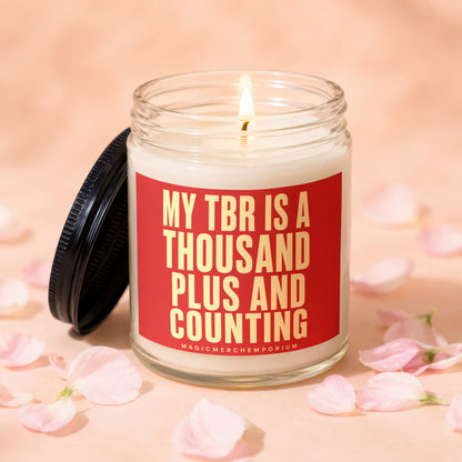 Glass candle with red label that says "My TBR is a thousand plus and counting".