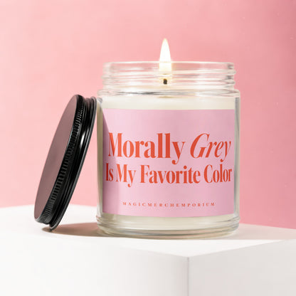 Candle with a lit wick and a pink label reading "Morally Grey Is My Favorite Color".