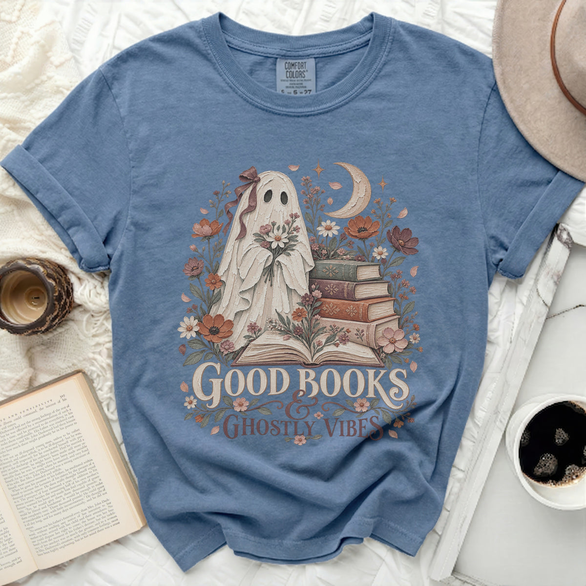 Ghost holding flowers with books and text "GOOD BOOKS GHOSTLY VIBES".