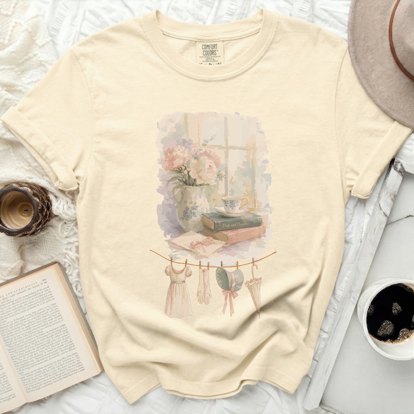 Cream t-shirt with watercolor print of vintage clothing on clothesline.