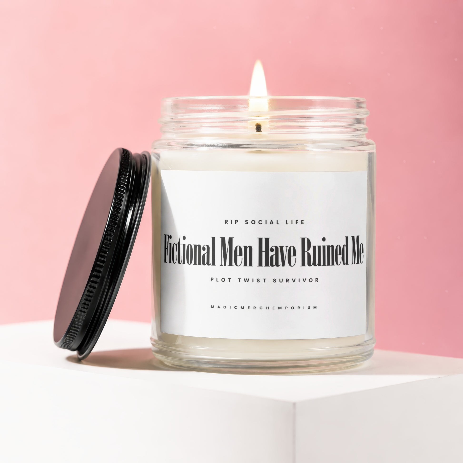 Scented candle in glass jar with black lid, reads "Fictional Men Have Ruined Me".