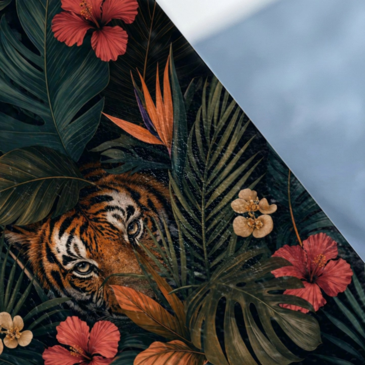 Tiger peeking through tropical leaves and flowers.
