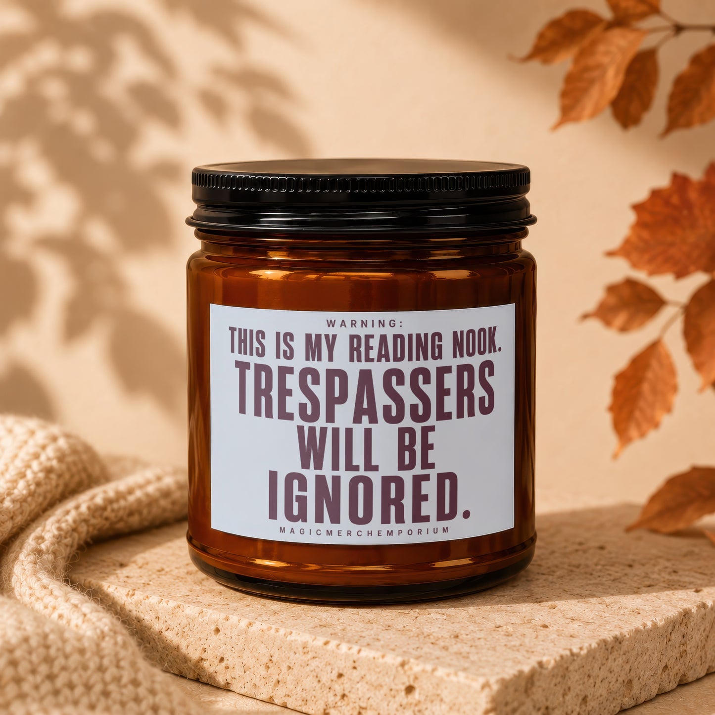 Brown glass candle with white label reading "THIS IS MY READING NOOK. TRESPASSERS WILL BE IGNORED."