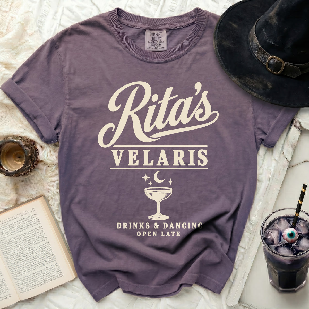 Purple t-shirt with "Rita's Velaris Drinks & Dancing Open Late" text.