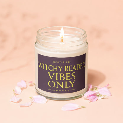 Candle with label "Certified Witchy Reader Vibes Only" surrounded by pink petals.