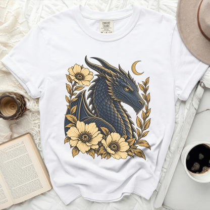 White t-shirt with a dark blue dragon and yellow flowers graphic and a crescent moon.