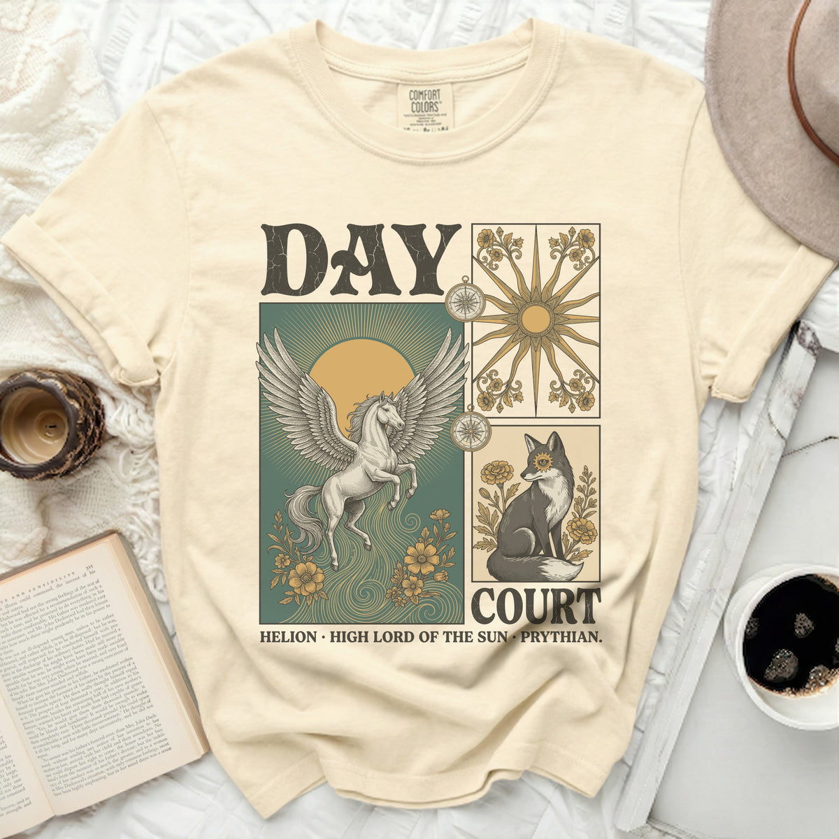 Cream t-shirt with "DAY COURT" graphic featuring pegasus, fox, sun, and compass.