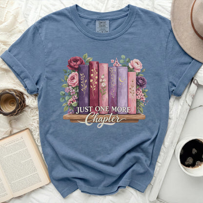 Blue t-shirt with "Just One More Chapter" and floral book graphic.