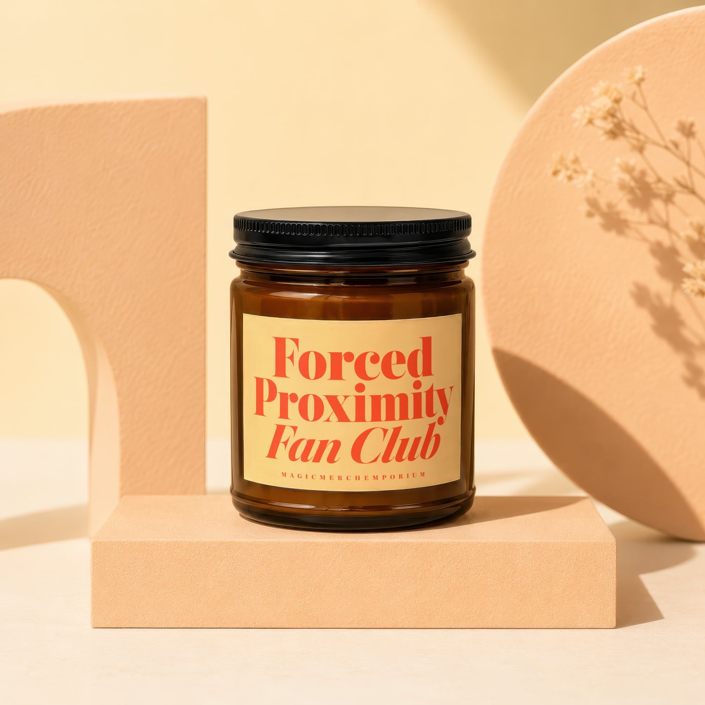 Brown glass candle with cream label reading "Forced Proximity Fan Club."