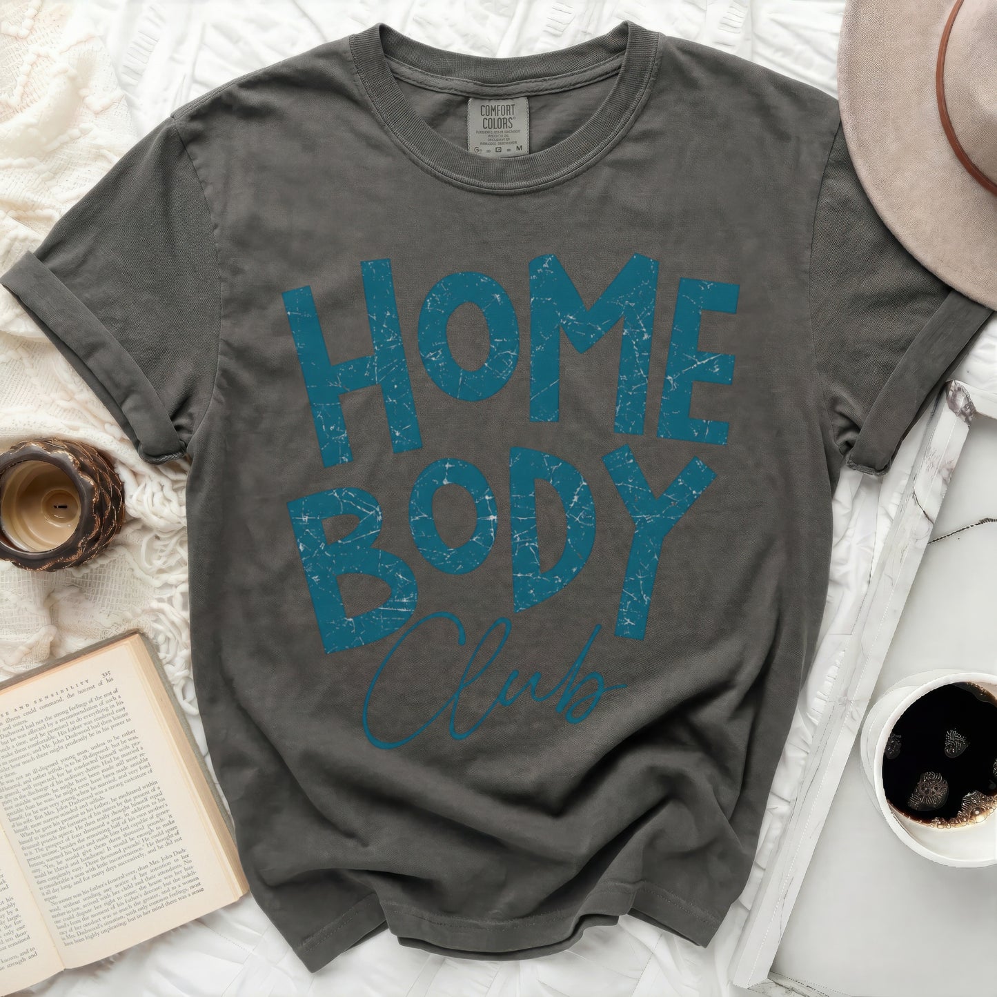 Dark gray t-shirt with "HOME BODY Club" text in teal.
