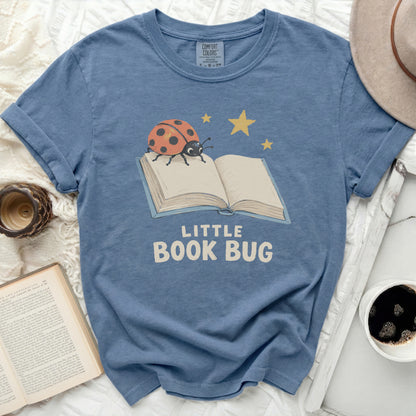 Blue t-shirt with "Little Book Bug" graphic featuring a ladybug on an open book.