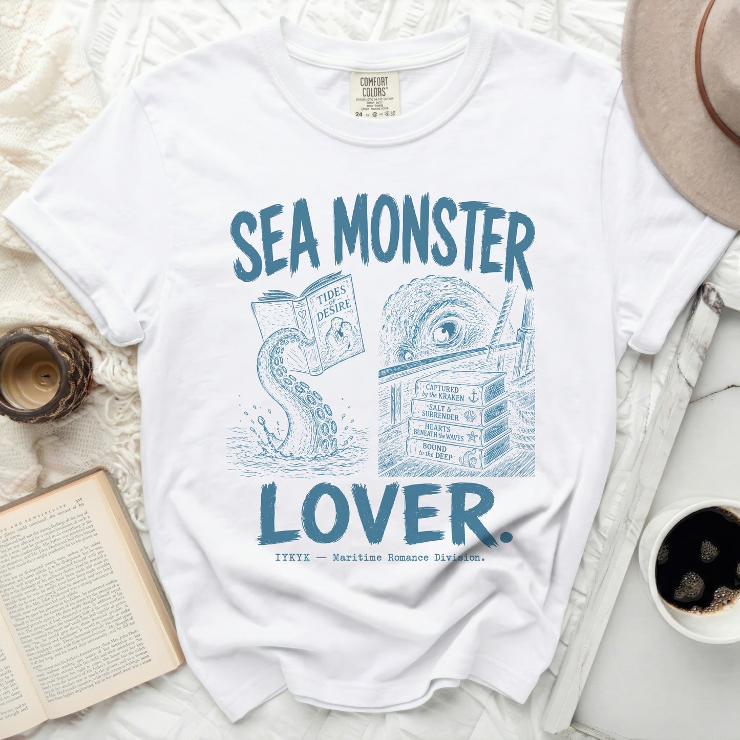White t-shirt with "SEA MONSTER LOVER" in blue text and nautical illustrations.