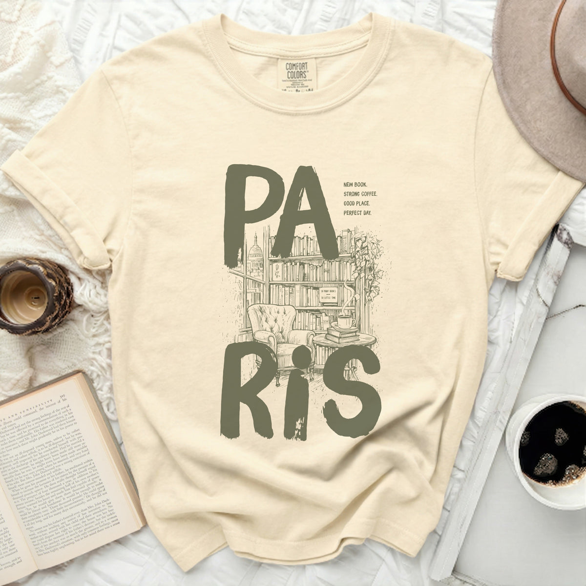 Cream t-shirt with "PA RIS" text over an illustration of a library and armchair.