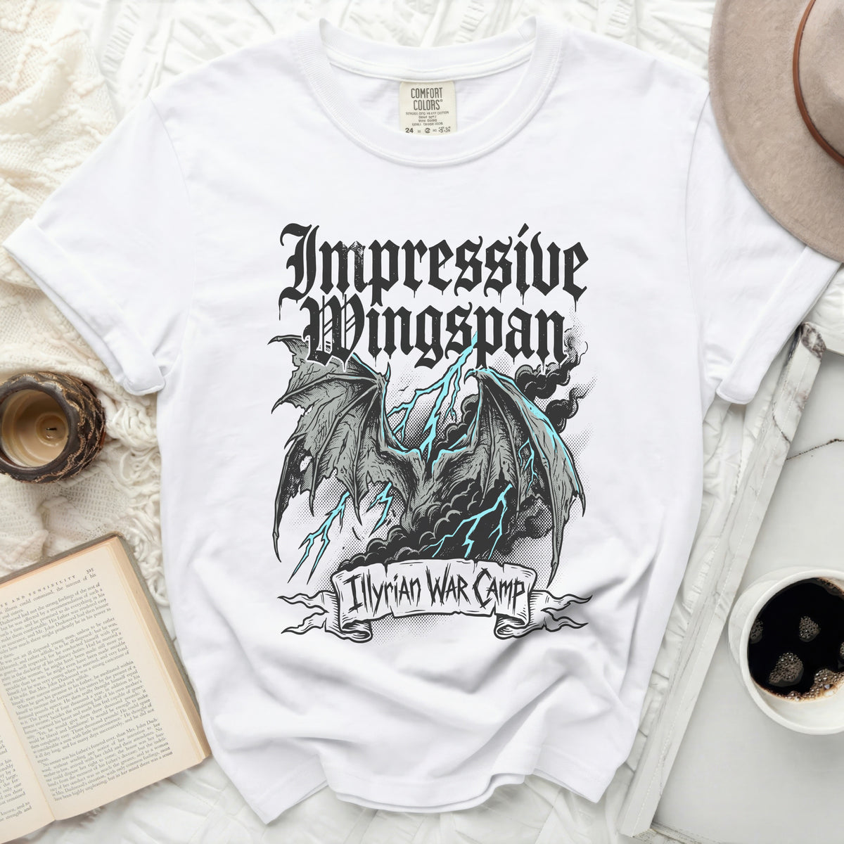 White Comfort Colors t-shirt with "Impressive Wingspan" and "Illyrian War Camp" graphic.