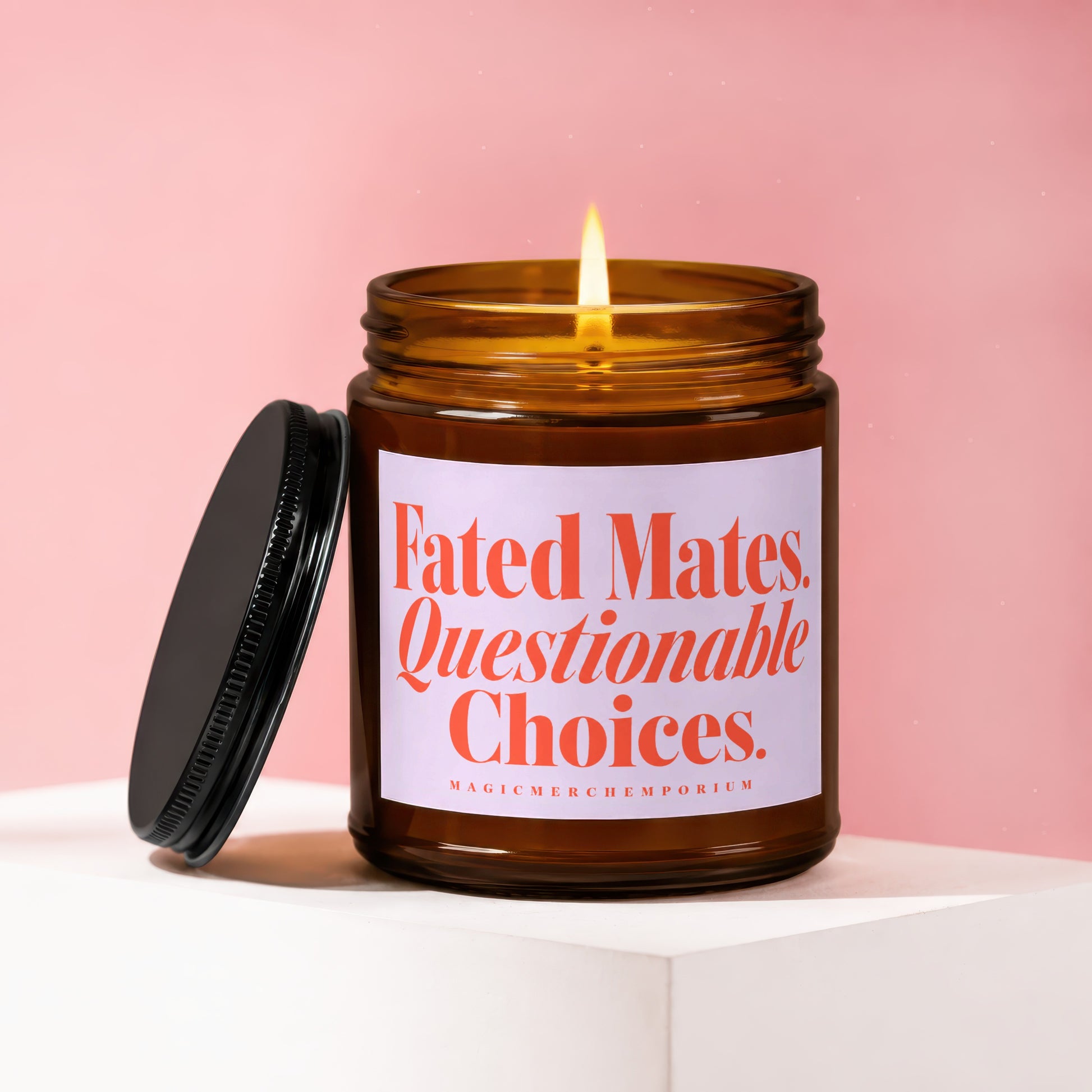 Amber jar candle with lit wick and lid, labeled "Fated Mates. Questionable Choices."