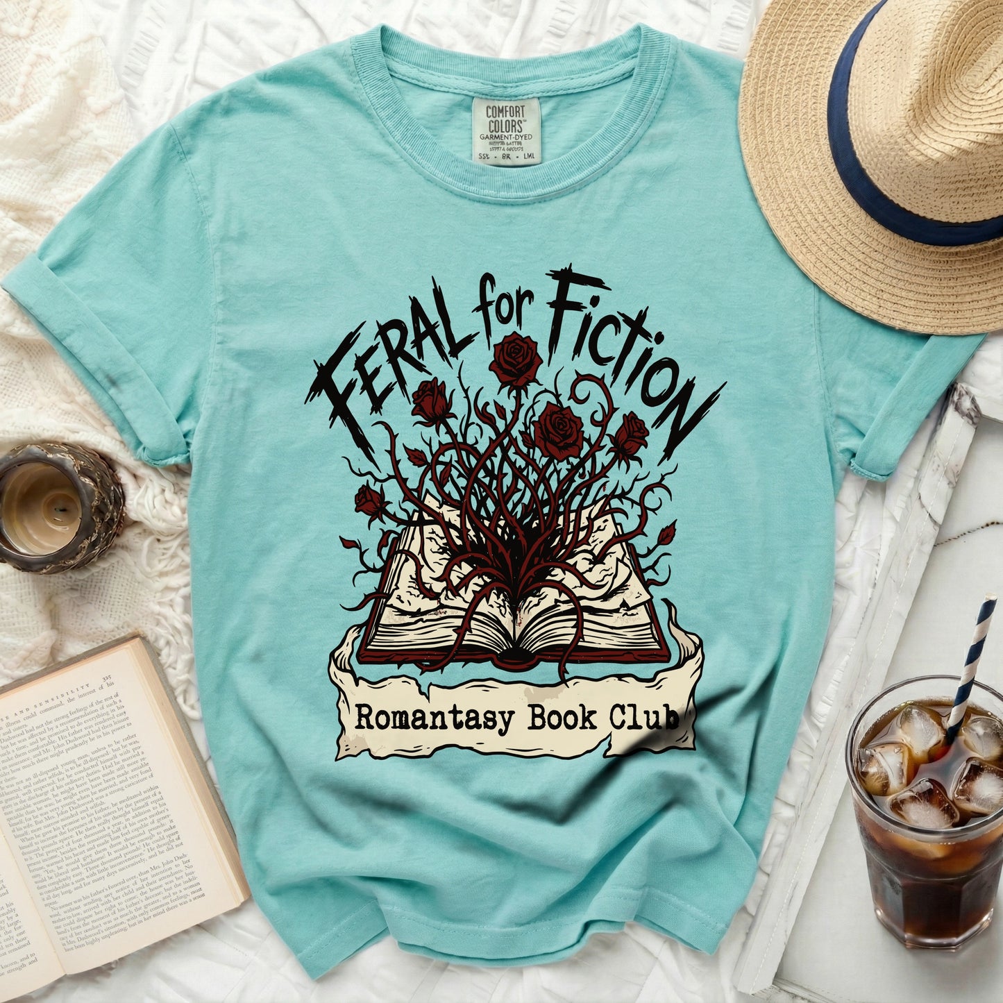 Teal t-shirt with "Feral for Fiction" and "Romantasy Book Club" text.