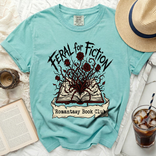 Teal t-shirt with "Feral for Fiction" and "Romantasy Book Club" text.