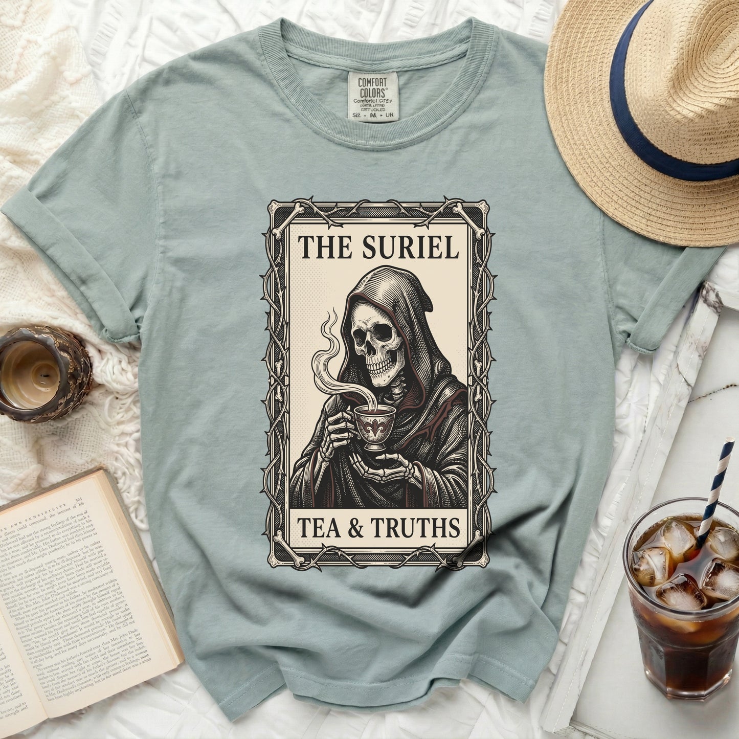 T-shirt with grim reaper drinking tea and text "THE SURIEL TEA & TRUTHS".
