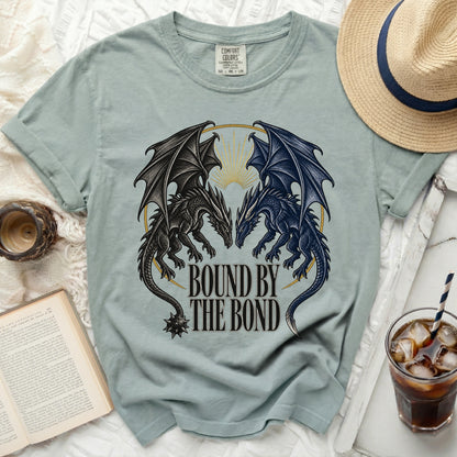 Light teal t-shirt with graphic of two dragons and text "Bound By The Bond".