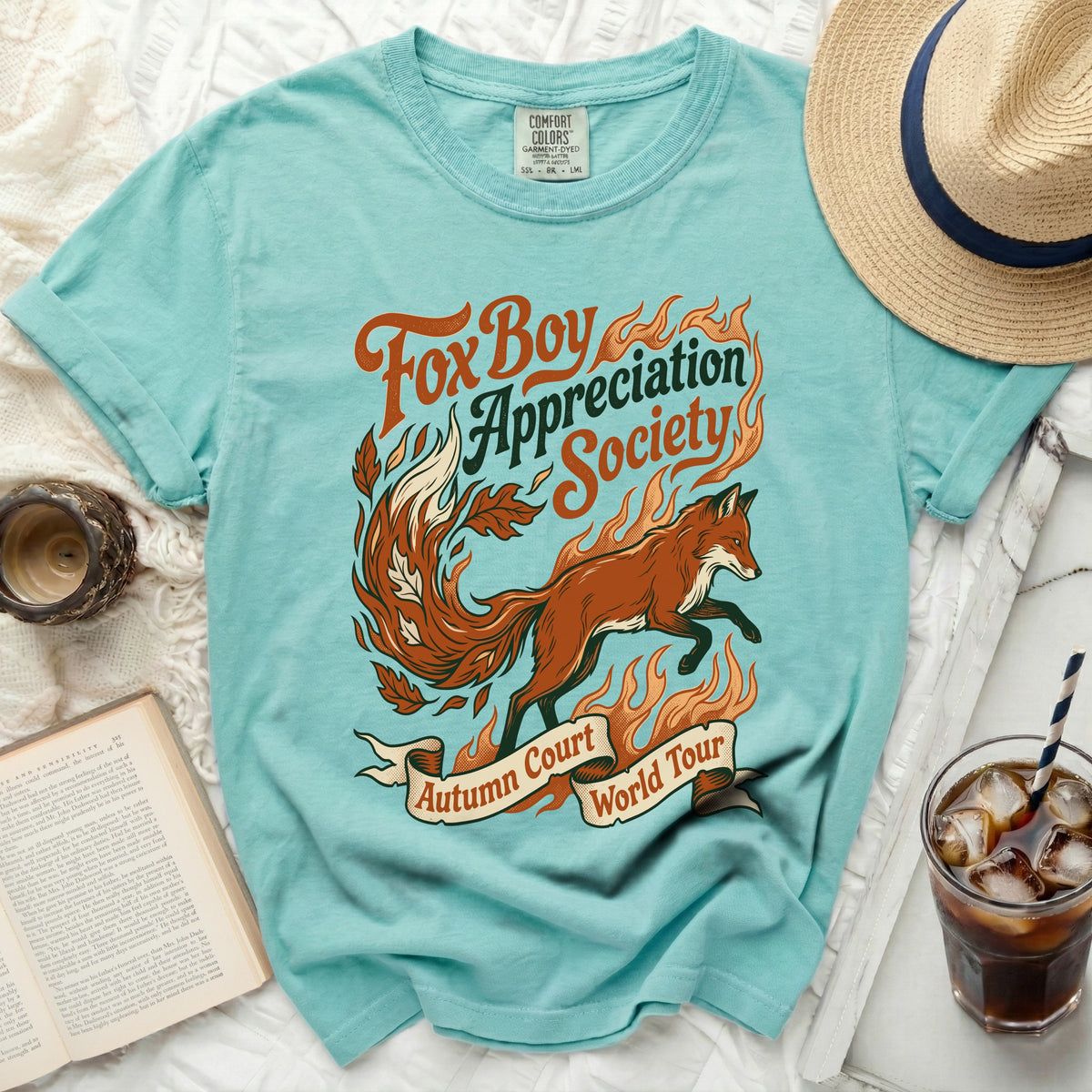 Teal t-shirt with "Fox Boy Appreciation Society Autumn Court World Tour" text and fox graphic.