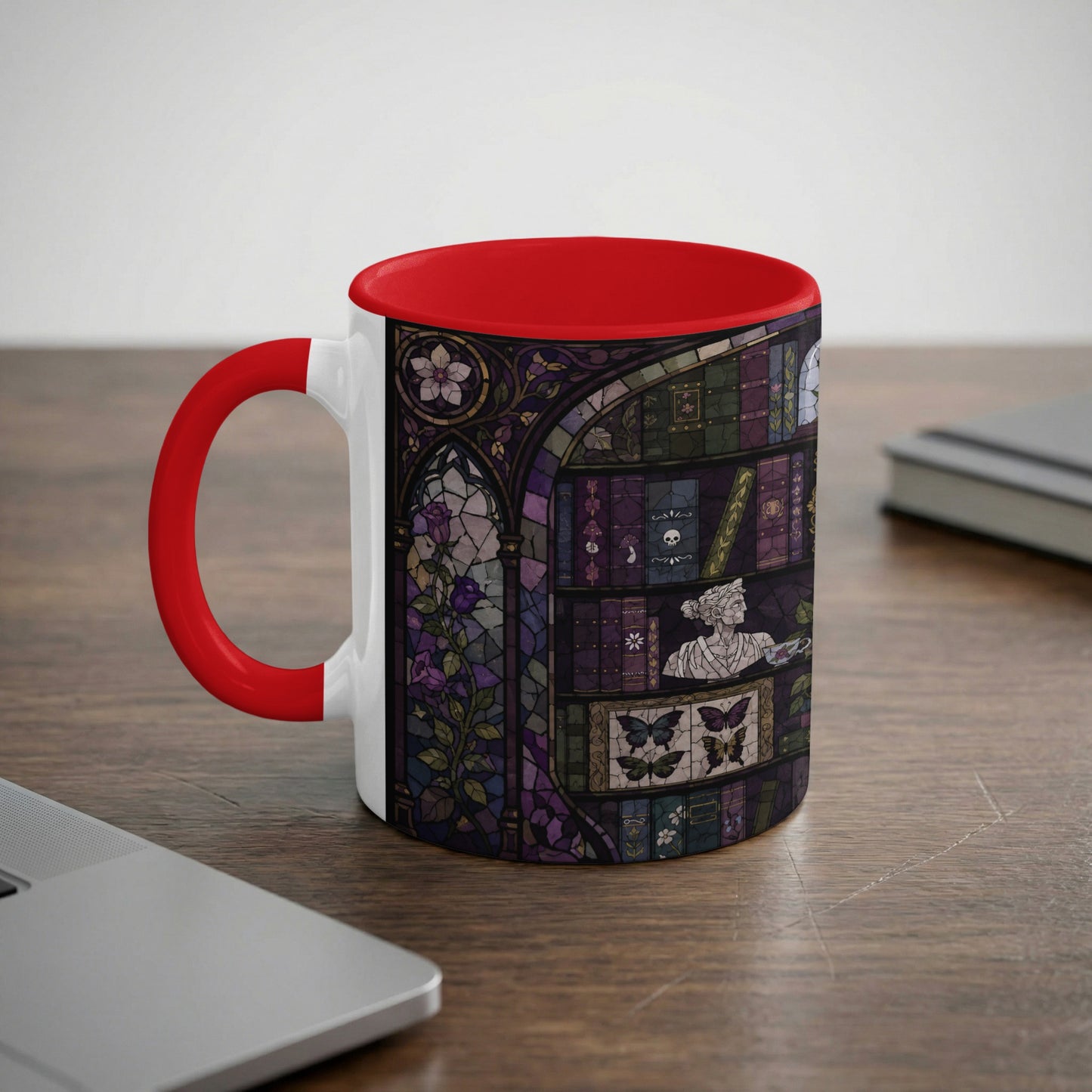 White mug with red handle and interior featuring gothic stained glass book and butterfly design.