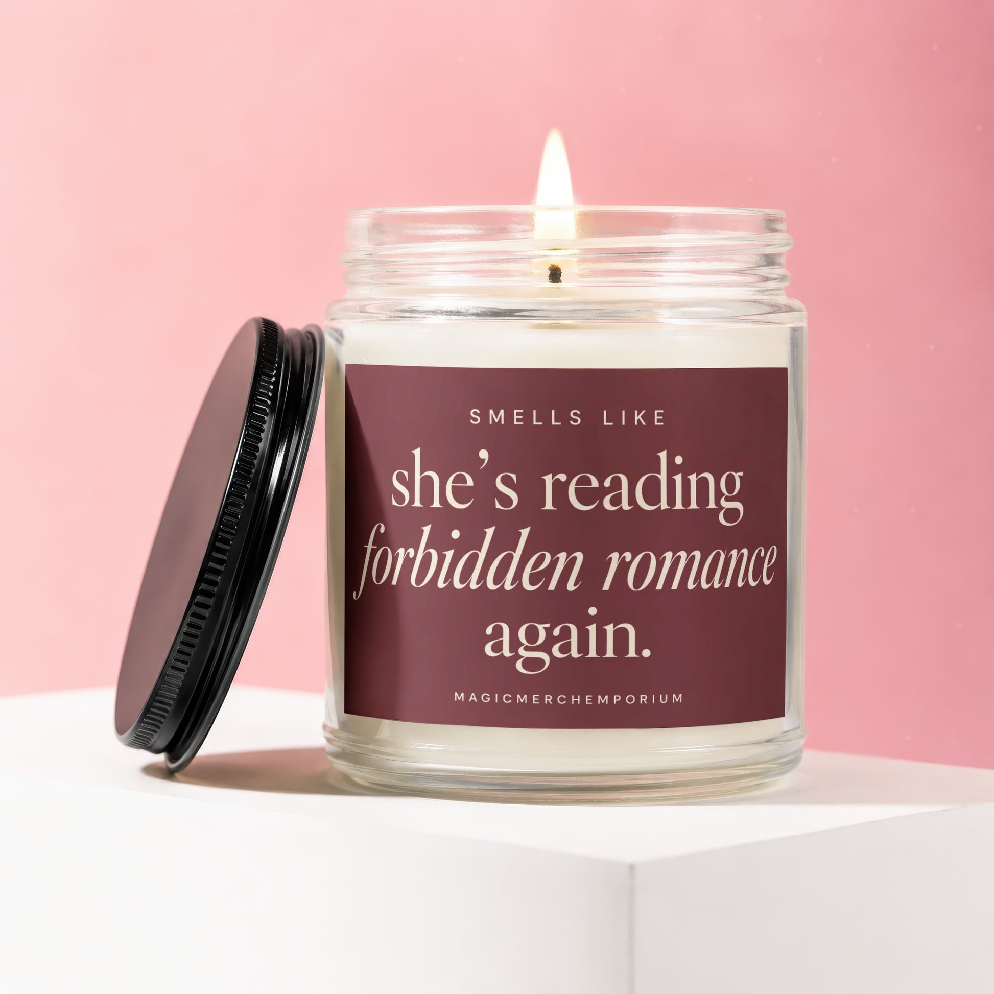 Scented candle with text "smells like she's reading forbidden romance again."