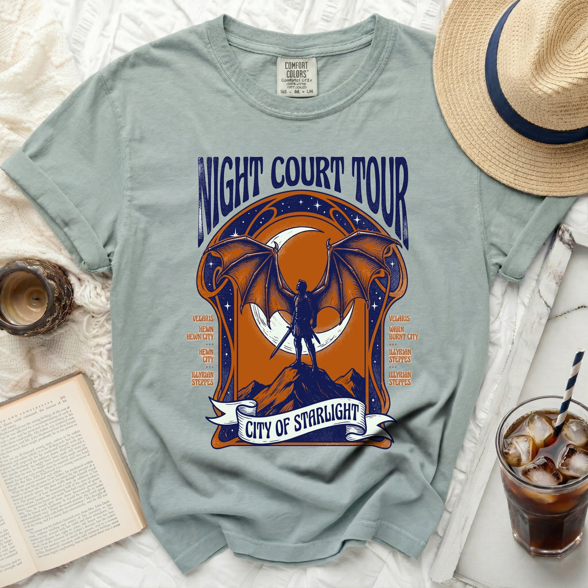 Light teal t-shirt with "Night Court Tour City of Starlight" graphic.
