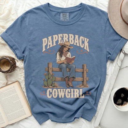 Graphic tee with "Paperback Cowgirl" text and illustration of a cowgirl reading.