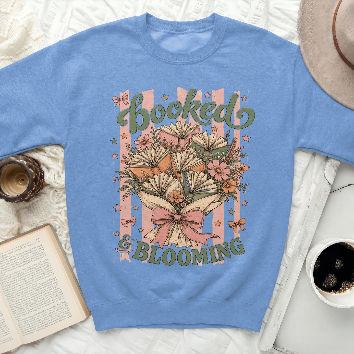 Sweatshirt with "Booked & Blooming" text and bouquet of books and flowers.