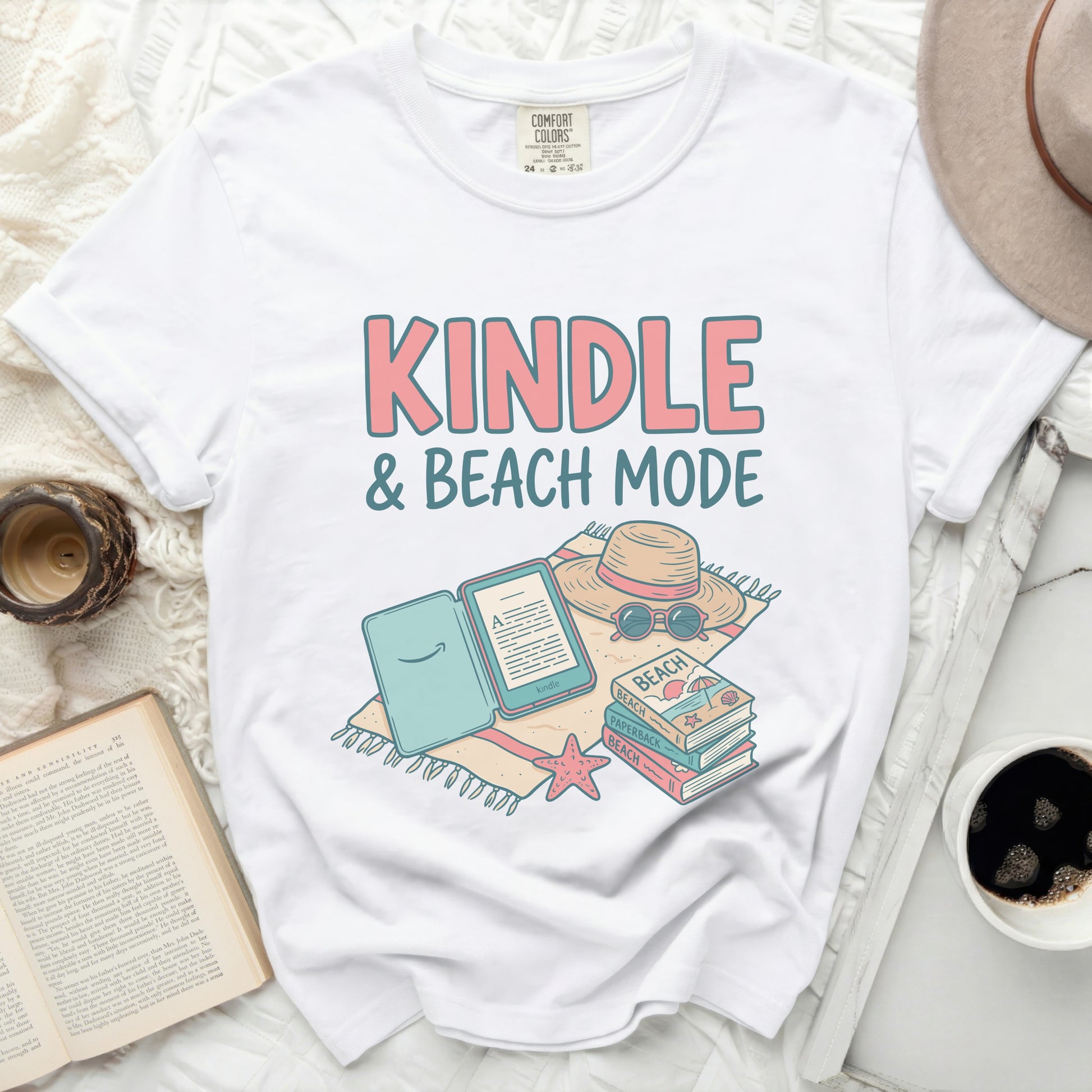 White t-shirt with "KINDLE & BEACH MODE" text and beach-themed icons.