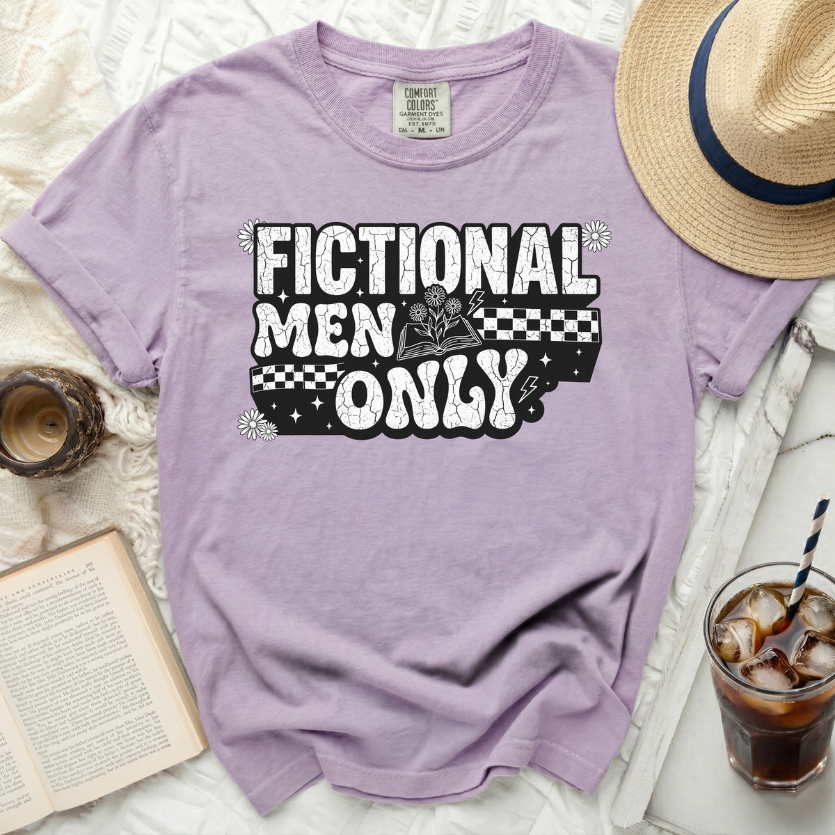Purple t-shirt with "Fictional Men Only" graphic, book, and flowers.