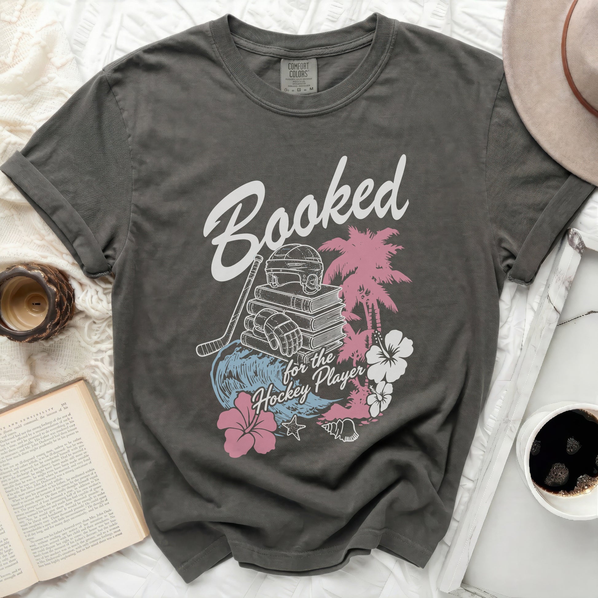 Dark gray t-shirt with "Booked for the Hockey Player" text and graphics.